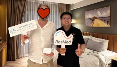 ResMed AirMini travel CPAP machine placed on bedside table showing compact setup for sleep apnea therapy at home before travel.